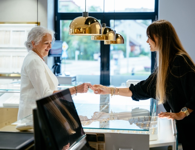 Two women checking out jewelries in a jewelry store